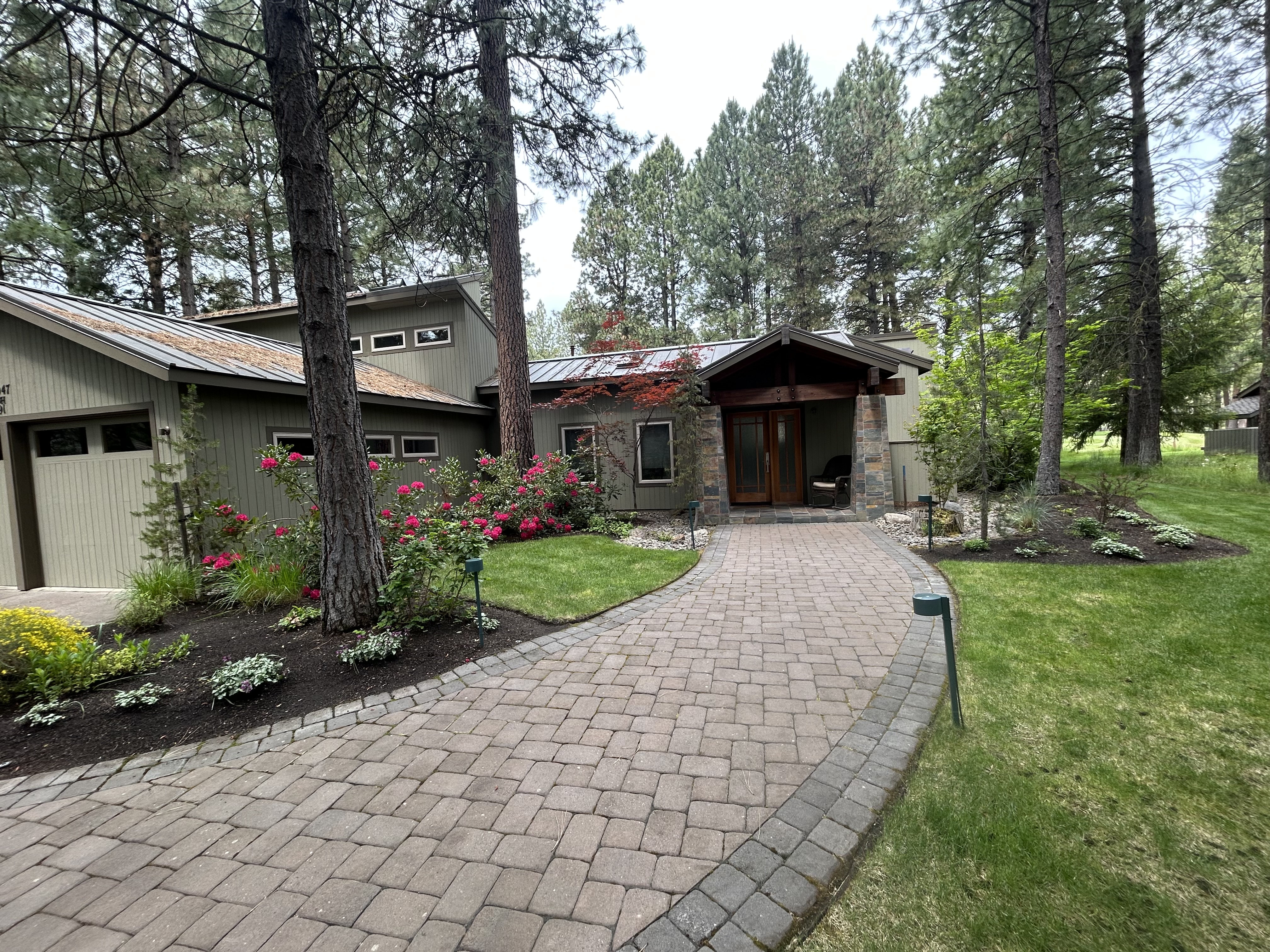 Expert paver job and lush landscaping at a residential home done by Sisters Landscape in in Central Oregon